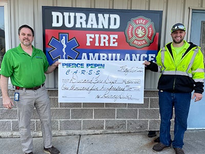 Trevor Myers (right) received check from PP Cares